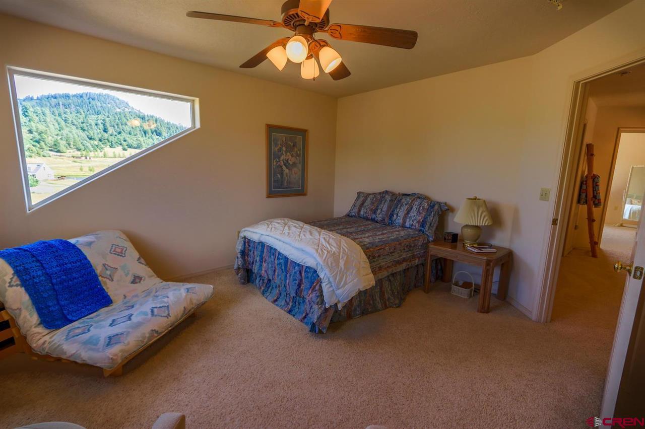 75 Pebble Circle Pagosa Springs, CO 81147 - Photo 19 of 30 a bedroom with a bed and window