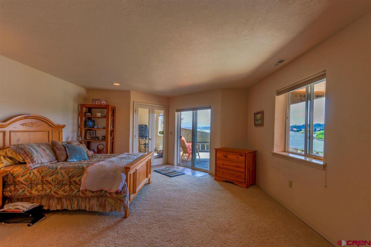 75 Pebble Circle Pagosa Springs, CO 81147 - Photo 25 of 30 a bedroom with a bed and a couch