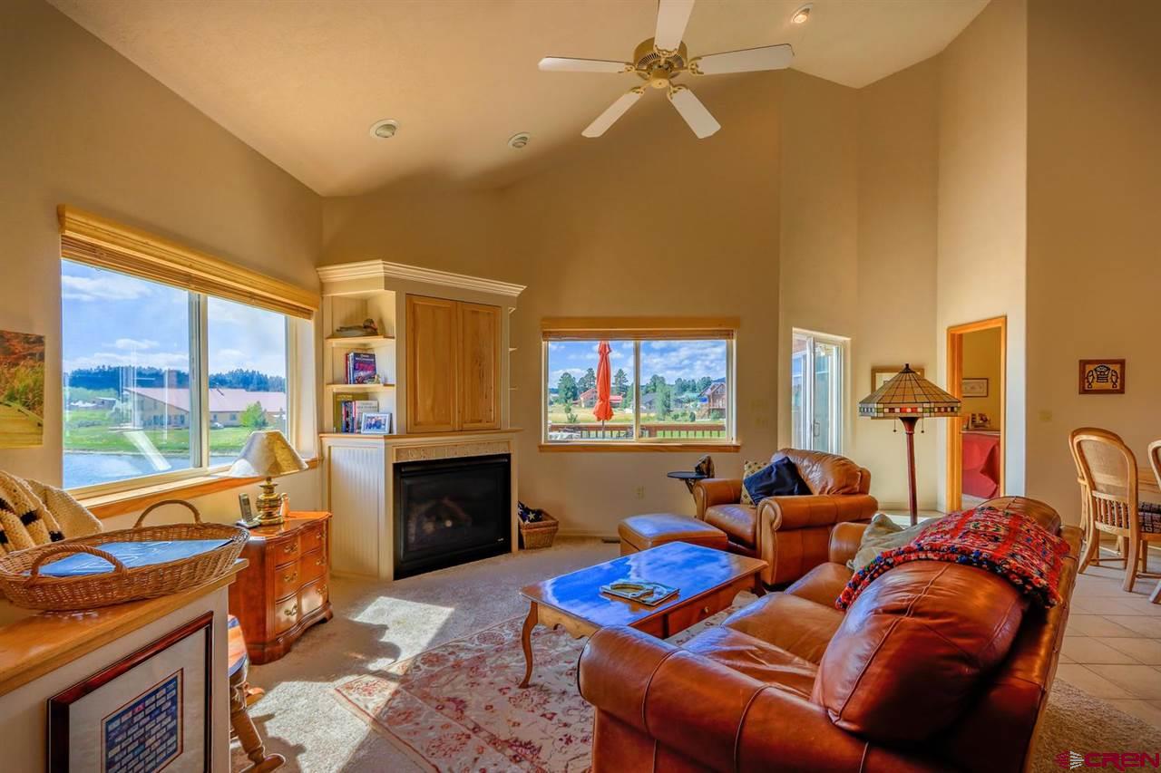 75 Pebble Circle Pagosa Springs, CO 81147 - Photo 6 of 30 a living room with furniture a fireplace and a flat screen tv