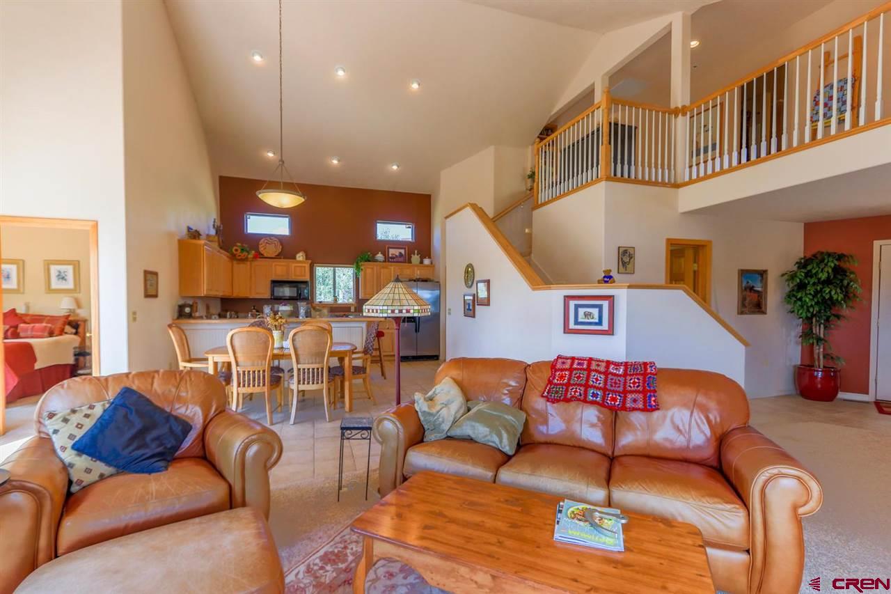 75 Pebble Circle Pagosa Springs, CO 81147 - Photo 10 of 30 a living room with furniture kitchen view and a wooden floor