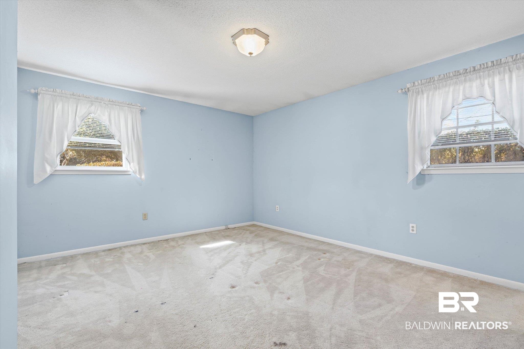 6300 Christopher Drive North Mobile, AL 36609 - Photo 10 of 22 Carpeted spare room with plenty of natural light and a textured ceiling