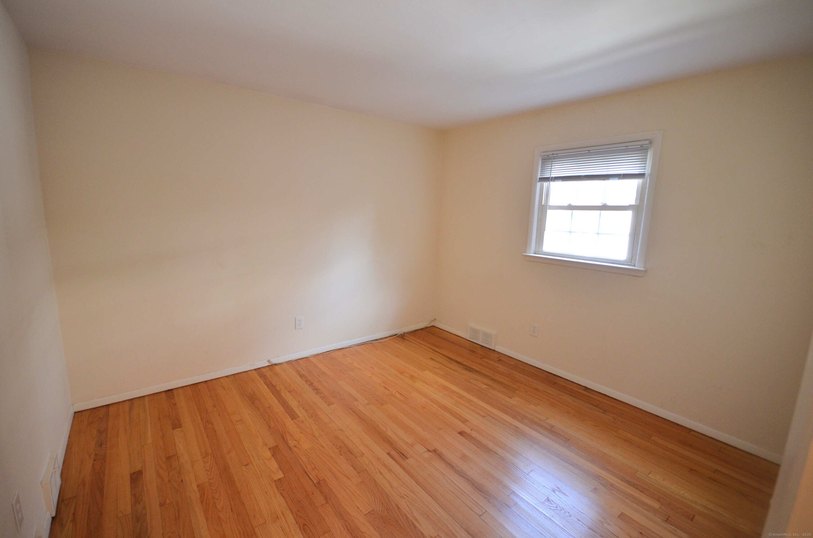 28 Riverside Drive Fairfield, CT 06824 - Photo 13 of 14 a view of an empty room with wooden floor and a window