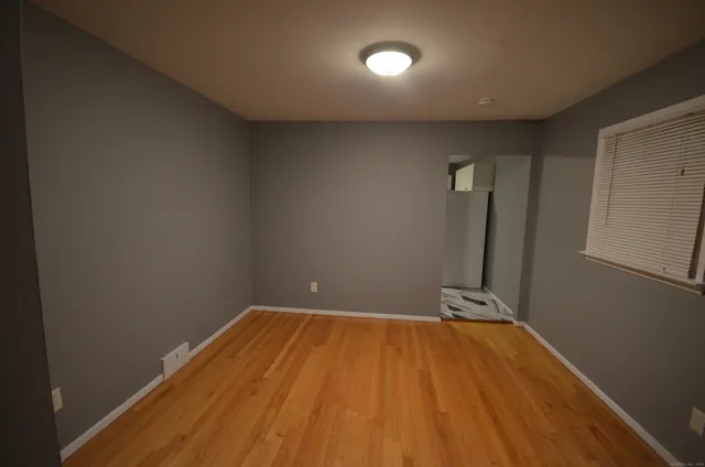 a view of a room with wooden floor