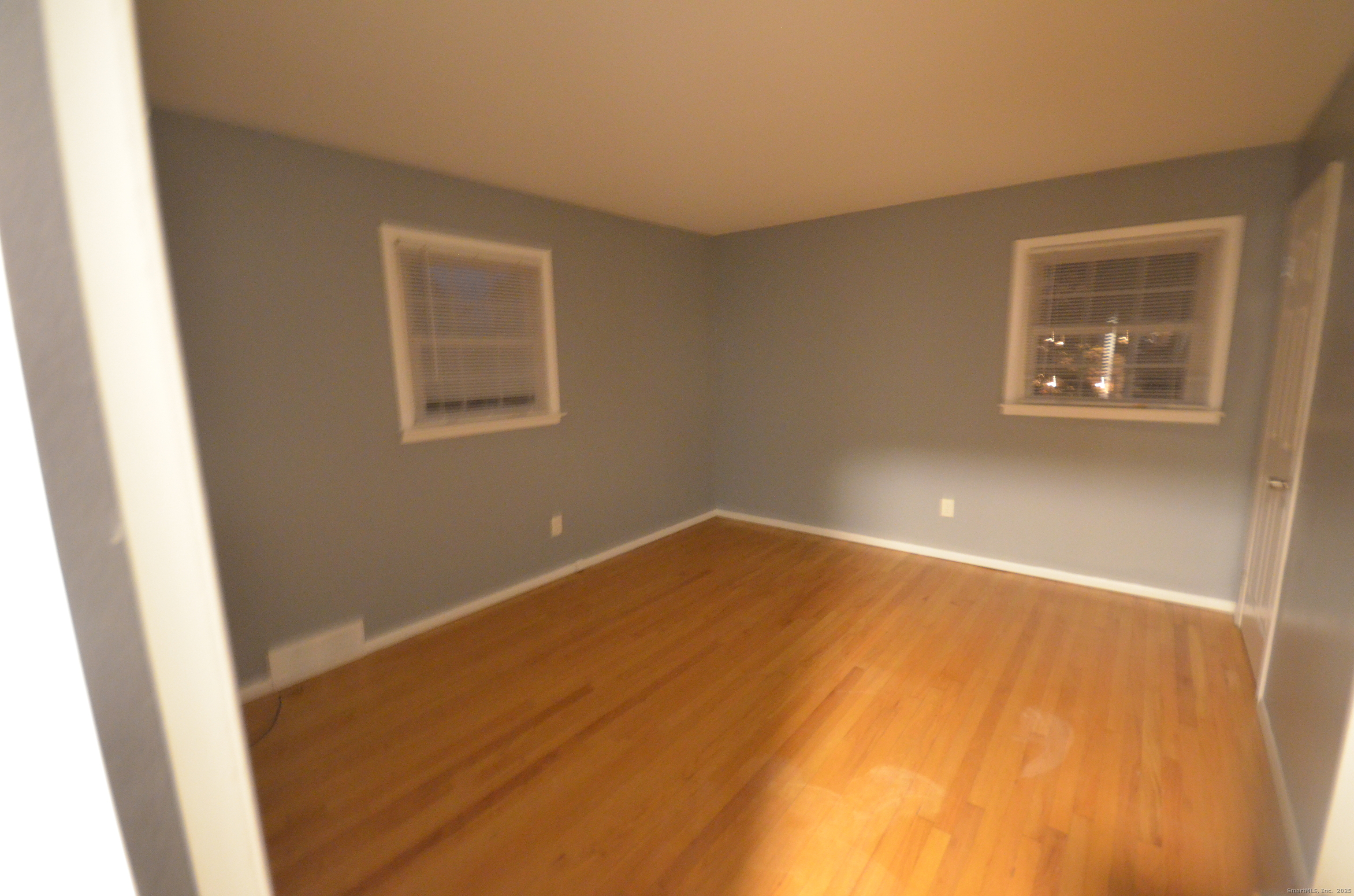 28 Riverside Drive Fairfield, CT 06824 - Photo 10 of 14 a view of an empty room with wooden floor and a window
