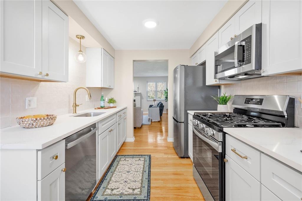 402 Forest Ridge Drive Pittsburgh, PA 15221 - Photo 11 of 35 a kitchen with stainless steel appliances granite countertop a stove a sink and a refrigerator