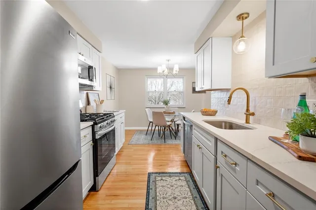a kitchen with granite countertop a sink and cabinets