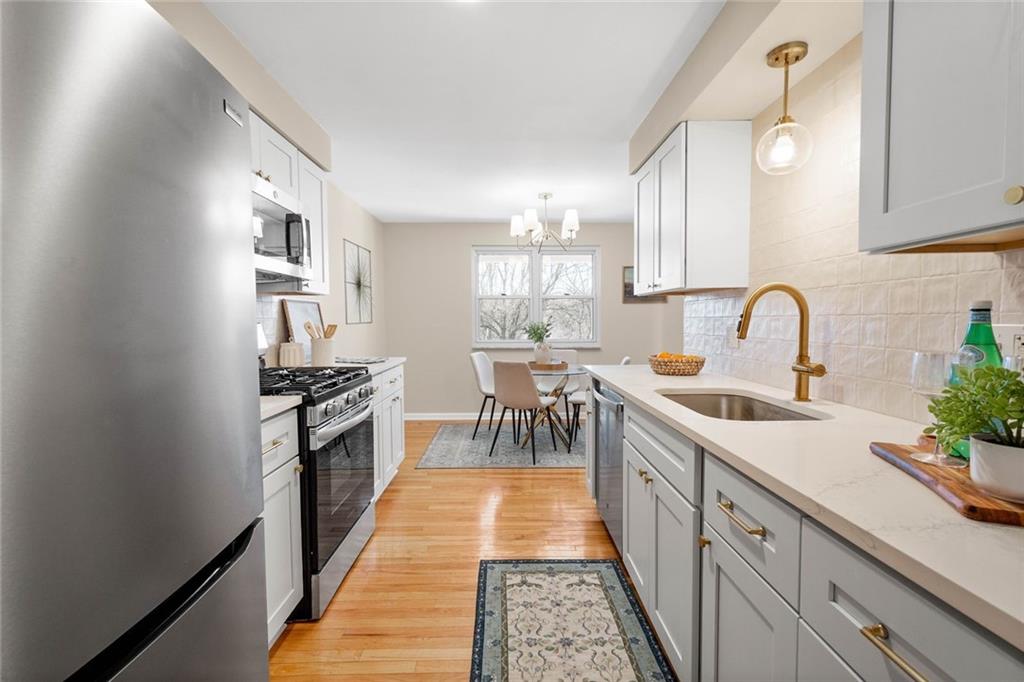 402 Forest Ridge Drive Pittsburgh, PA 15221 - Photo 14 of 35 a kitchen with granite countertop a sink and cabinets