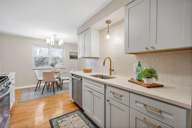 a kitchen with a sink cabinets and window
