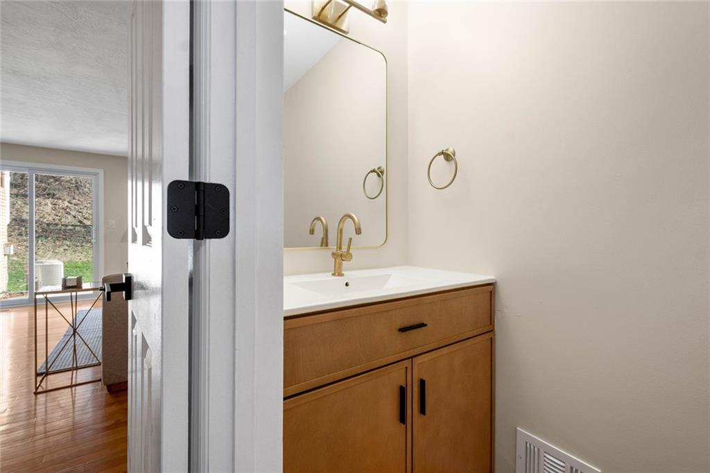 402 Forest Ridge Drive Pittsburgh, PA 15221 - Photo 18 of 35 a bathroom with a sink and mirror