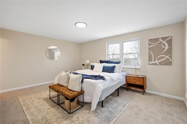 a bedroom with a bed and a couch