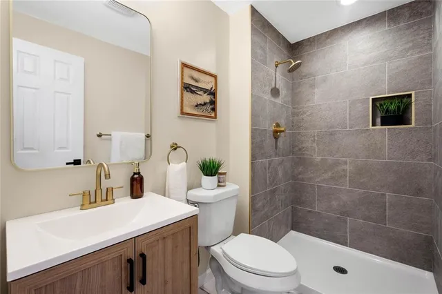 a bathroom with a sink a toilet and shower