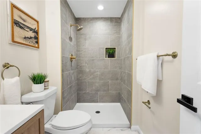 a bathroom with a toilet and a shower