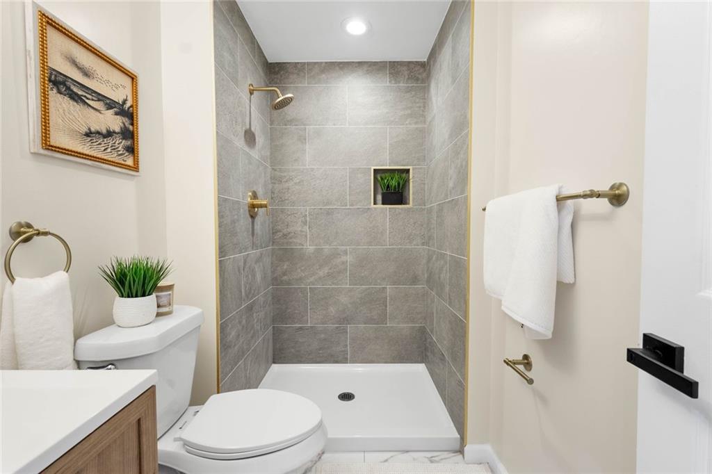 402 Forest Ridge Drive Pittsburgh, PA 15221 - Photo 22 of 35 a bathroom with a toilet and a shower