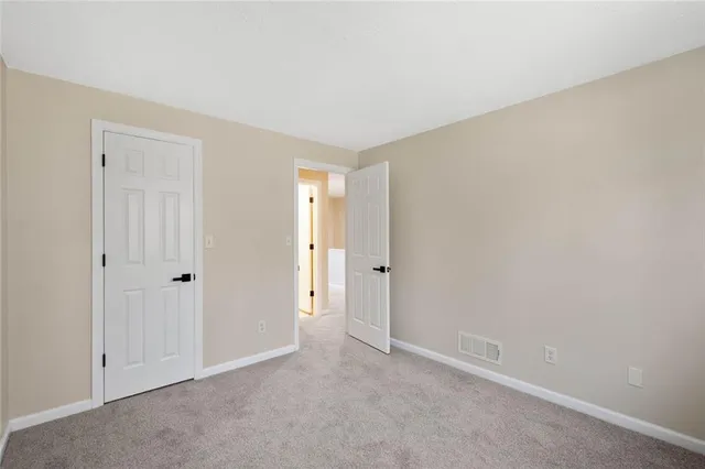 a view of an empty room and closet area