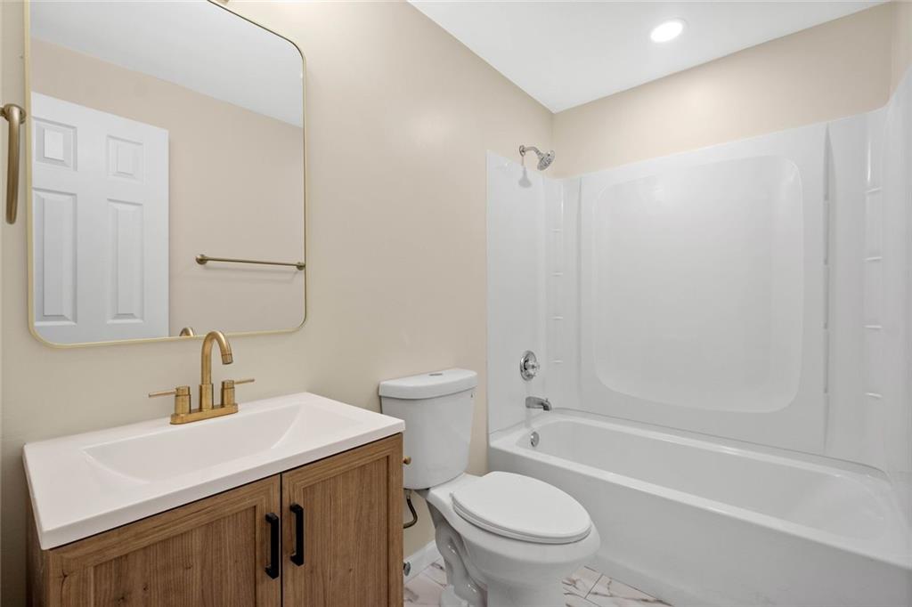 402 Forest Ridge Drive Pittsburgh, PA 15221 - Photo 25 of 35 a bathroom with a sink a toilet and shower