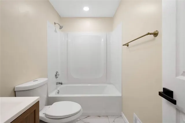 a bathroom with a toilet and a bathtub