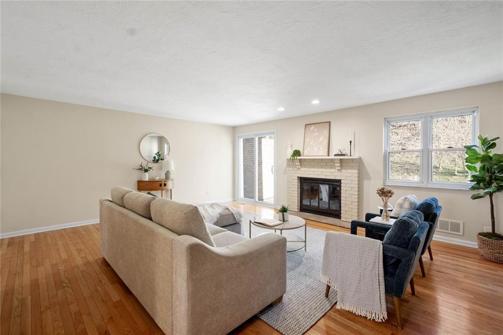 402 Forest Ridge Drive Pittsburgh, PA 15221 - Photo 8 of 35 a living room with furniture and a fireplace