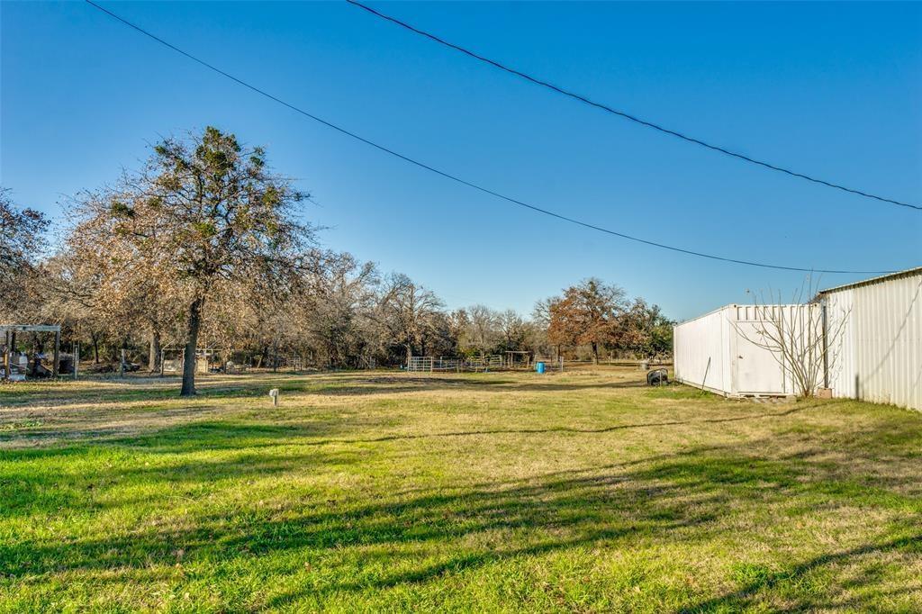 West side of property with the side of the barn in view. The RV hookups are located here. Water, Electricity, plumbing are all available.