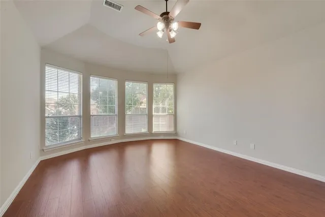 a view of room with window and wooden floor