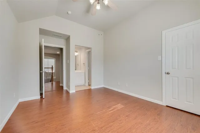 a view of an empty room and wooden floor