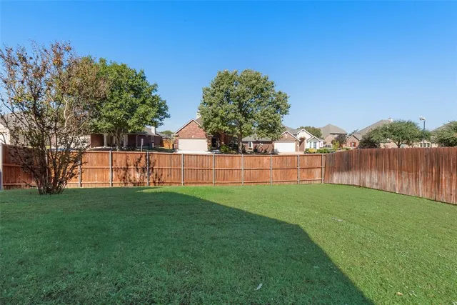 a view of a yard with a fence
