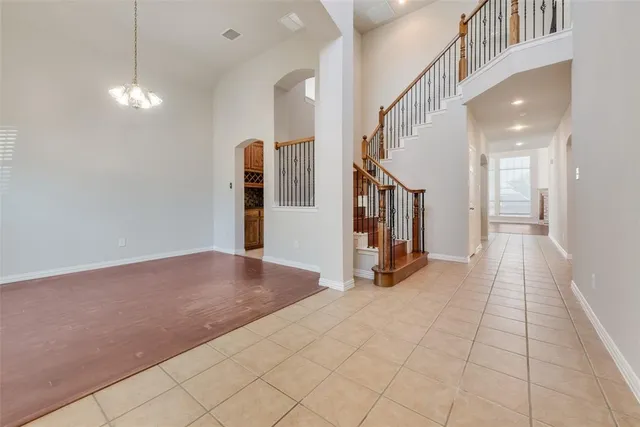a view of a hallway with entryway and chandelier