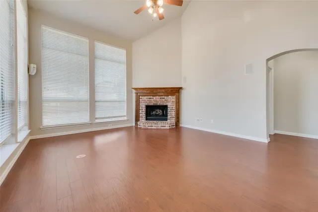 wooden floor fireplace and natural light in room