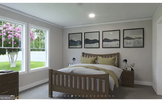 a bedroom with a bed a table and windows