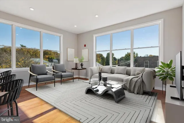a living room with furniture and a large window