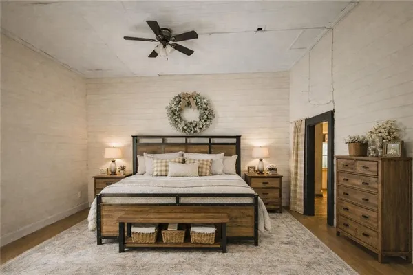 a bedroom with a bed and a chandelier