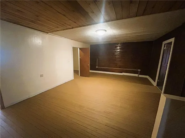 an empty room with wooden floor