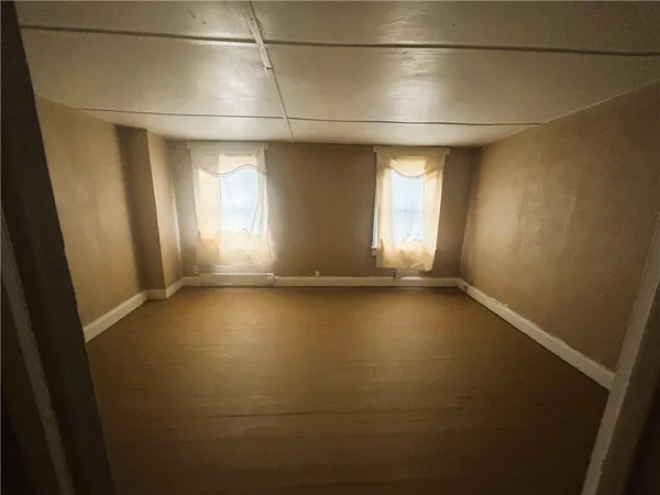 an empty room with a empty space and windows