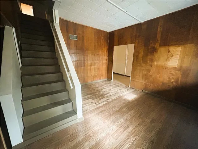 a view of entryway with wooden floor and stairs