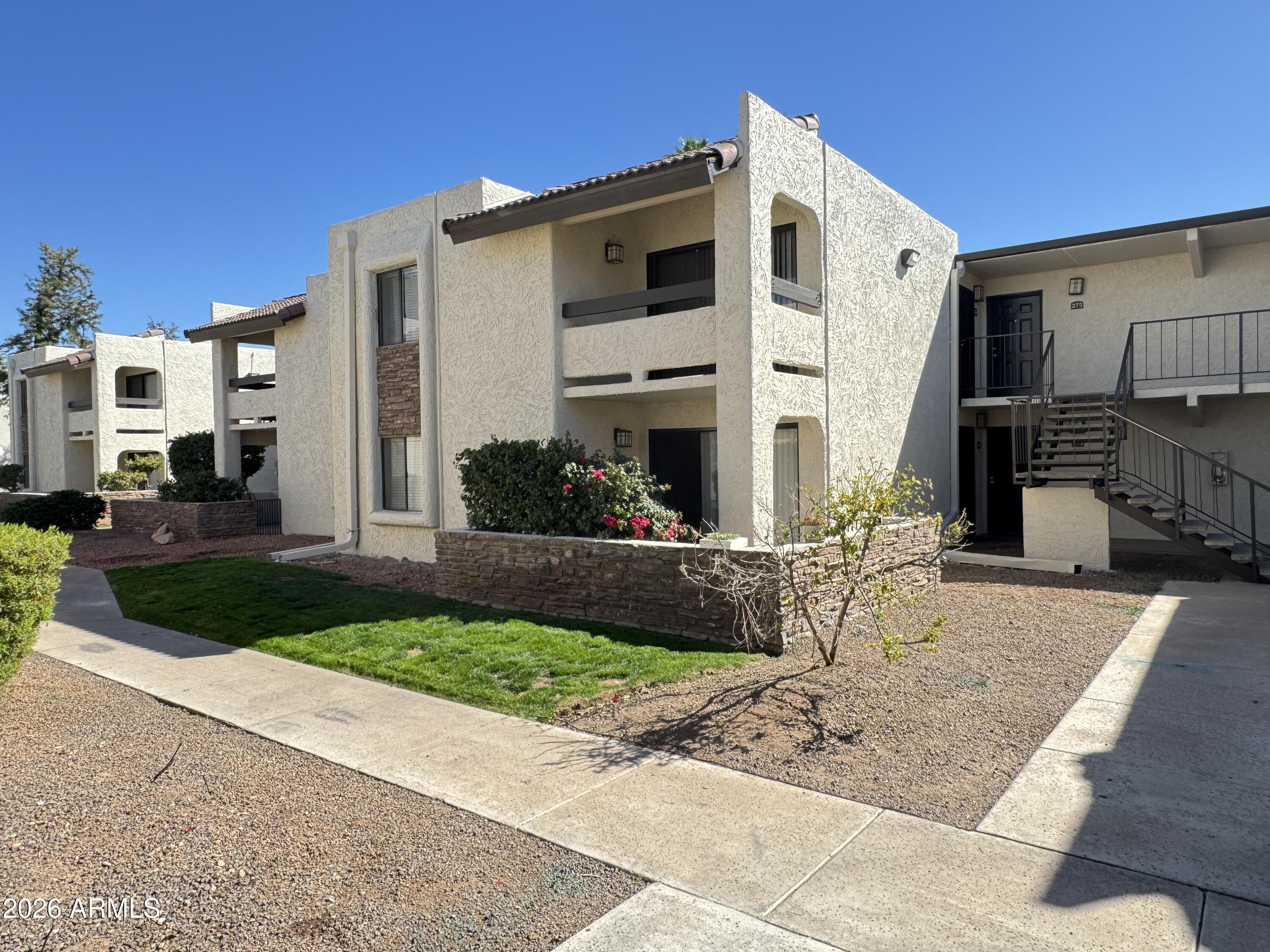 3825 East Camelback Road, Unit 276 Phoenix, AZ 85018 - Photo 1 of 12 a front view of a house with garden