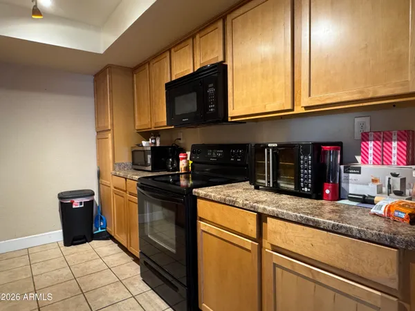 a kitchen with stainless steel appliances granite countertop a sink and a microwave