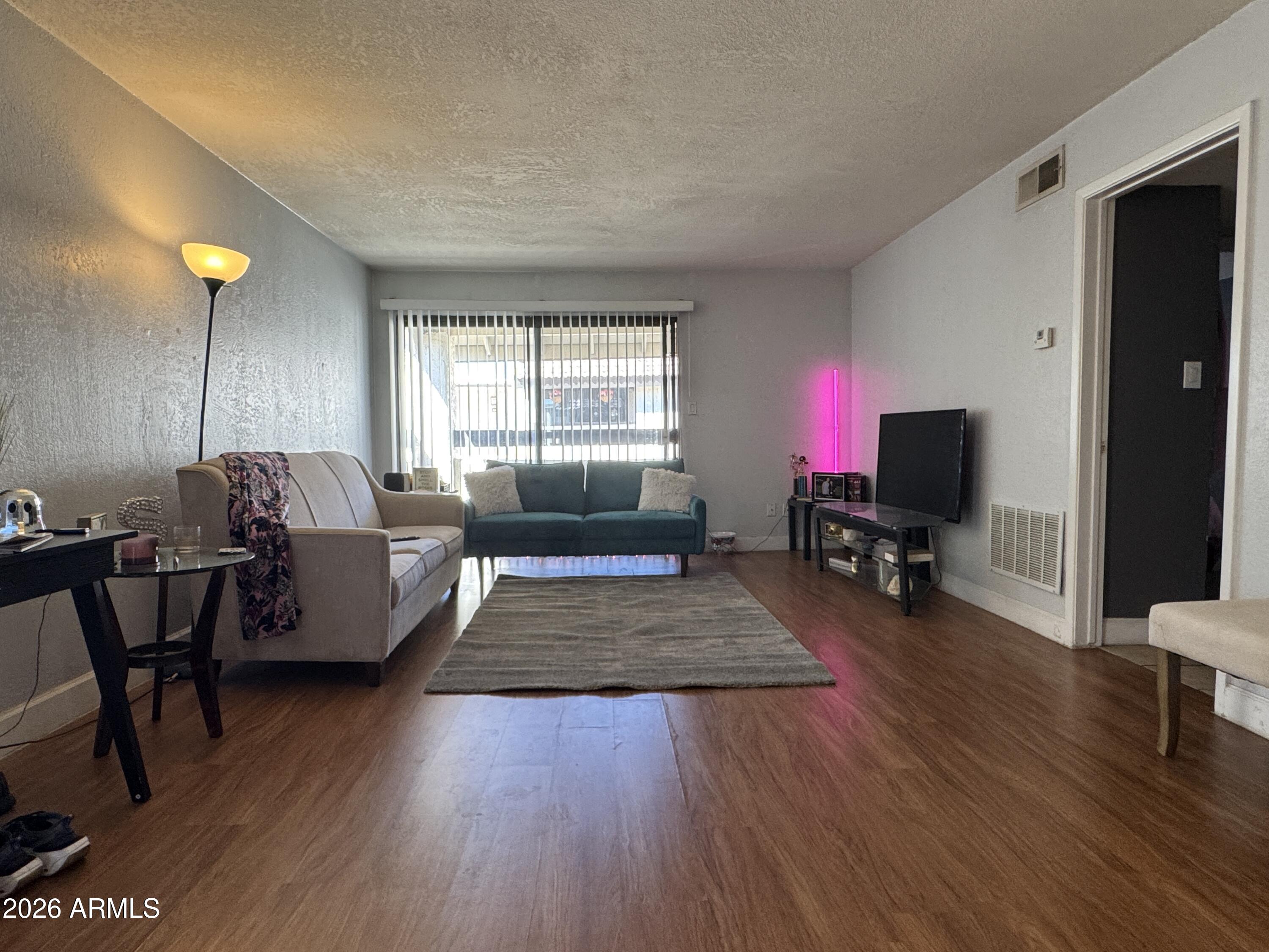 3825 East Camelback Road, Unit 276 Phoenix, AZ 85018 - Photo 4 of 12 a living room with furniture and a flat screen tv