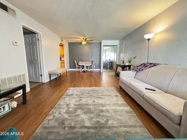 a living room with furniture and a wooden floor