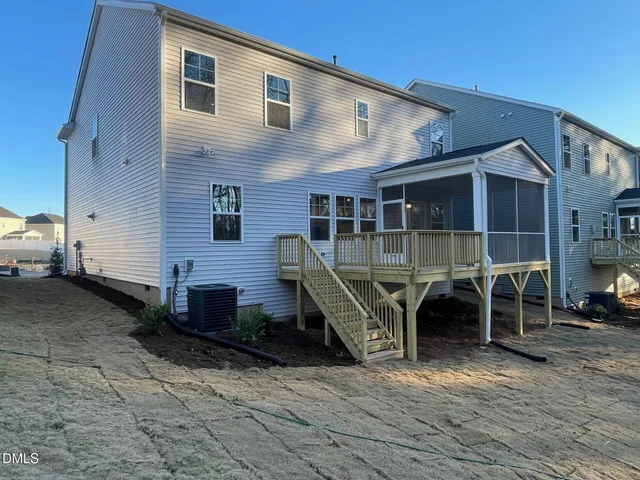a view of a house with wooden deck