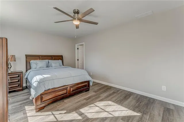 a bedroom with a bed and a ceiling fan