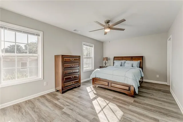a bedroom with a bed and wooden floor