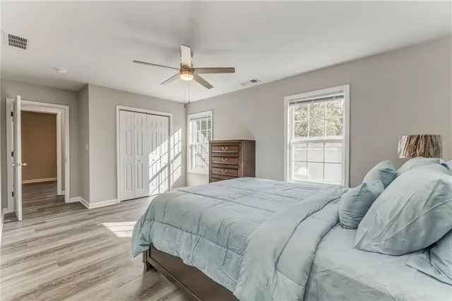 a bedroom with a large bed and a window