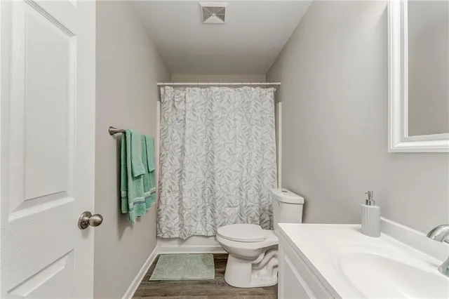 a bathroom with a toilet and shower