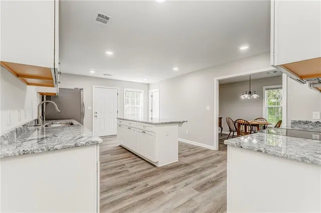 a kitchen with a sink stove and wooden cabinets