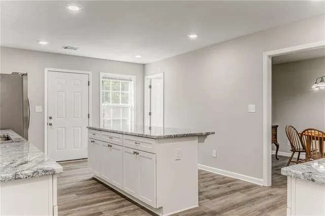 a view of a kitchen counter space and wooden floor