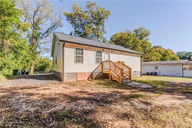 a view of a house with a yard and a garage