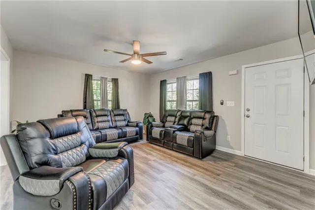 a living room with furniture and a wooden floor