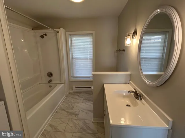 a bathroom with a tub and a shower