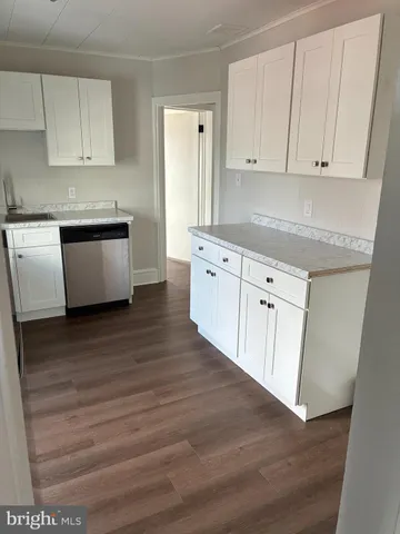 a kitchen with granite countertop white cabinets and white appliances
