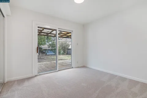 a view of an empty room with glass door