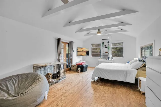 a bedroom with furniture and a large window